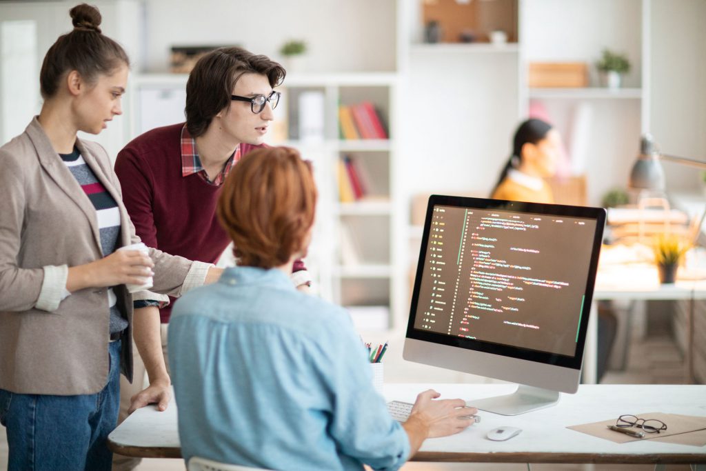 Staff Augmentation - Team reviewing code on a computer