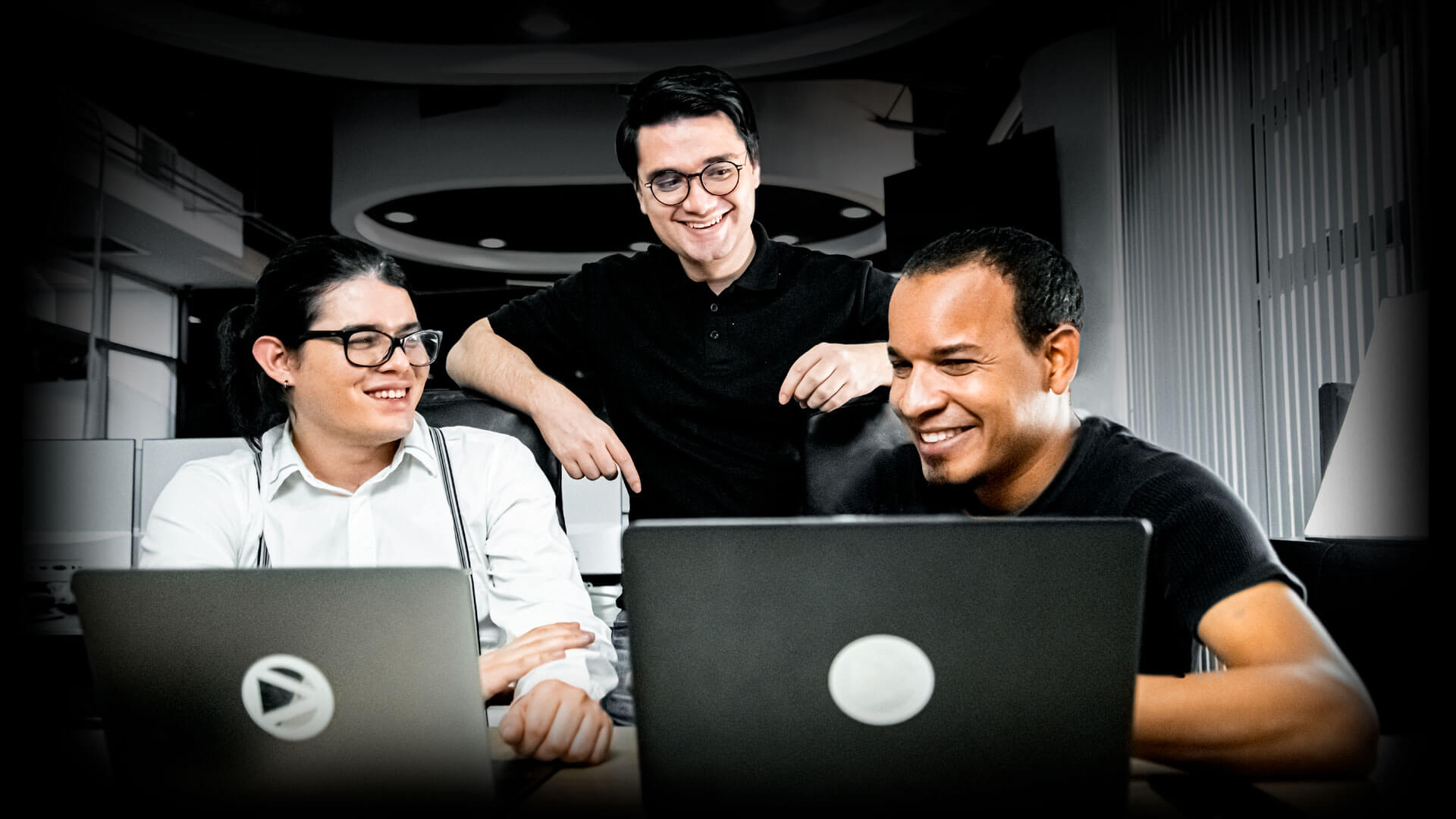 Three collaborators from Dnamic working with laptops