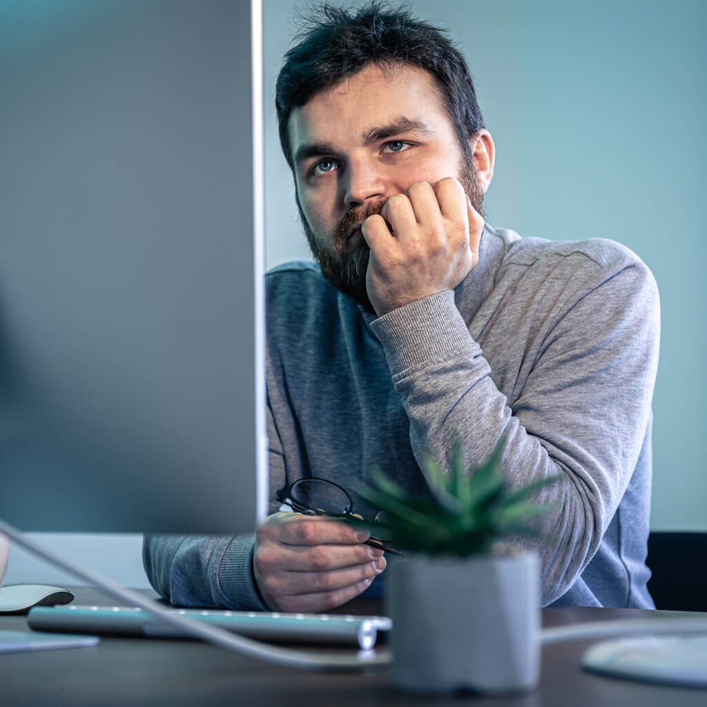 Worried man working on his computer